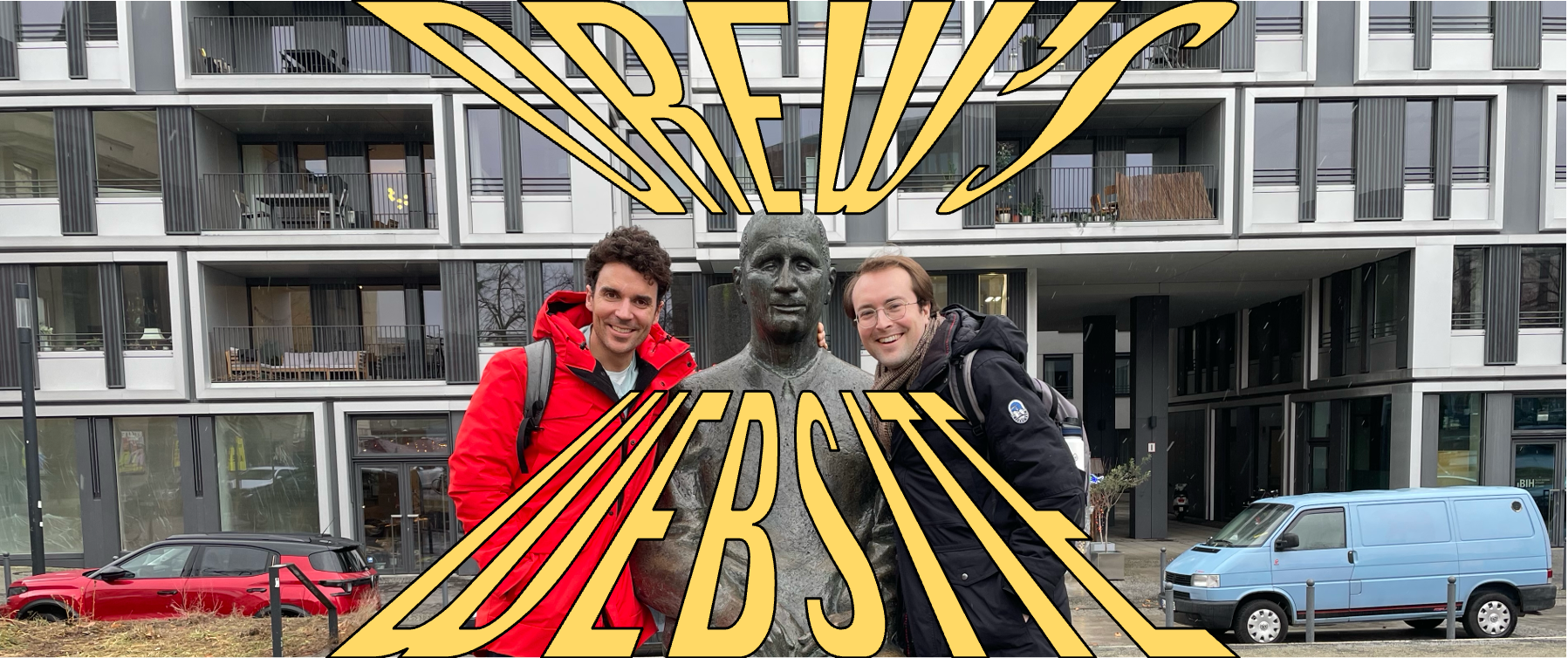 Author pictured with Troy Vettese and a statue of Bertolt Brecht, with the words Drew's Website over the top